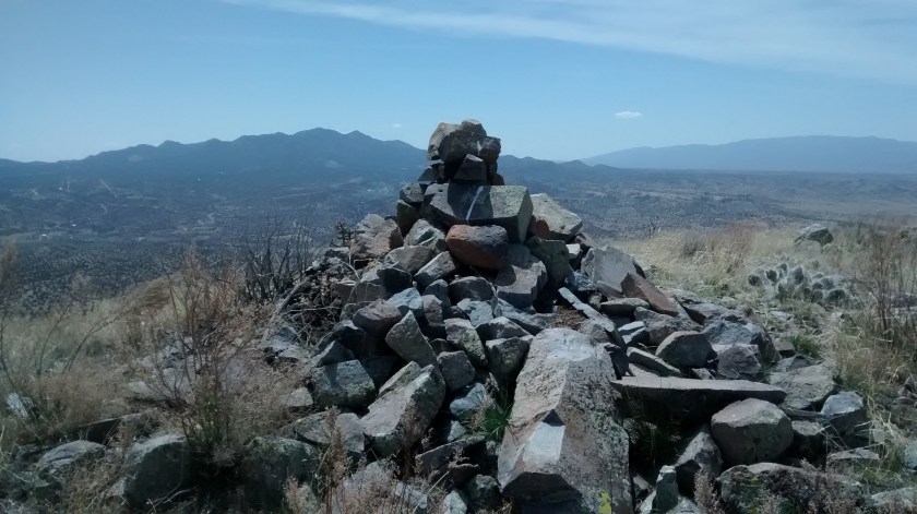 View south from summit.  Ortiz Mountains with Sandia Mountains in far distance.