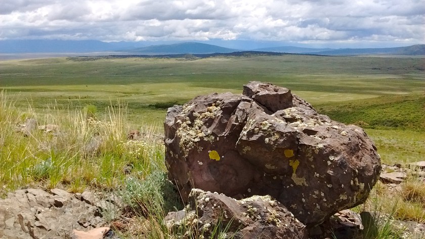 From partway up San Antonio Mountain looking east.  Highway 285 in the distance and beyond that Ute Mountain on Rio Grande del Norte National Monument.