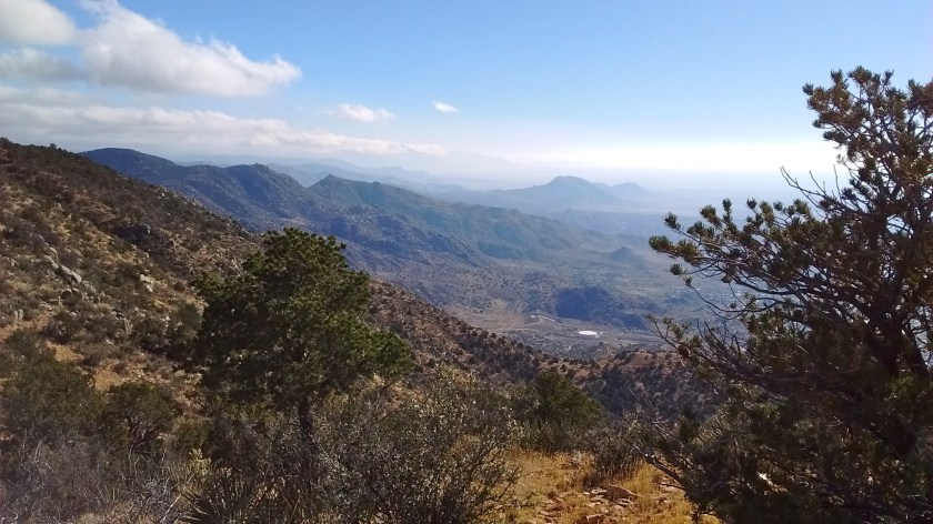 The parking lot is to the right of the water tank but no direct route to get there.
